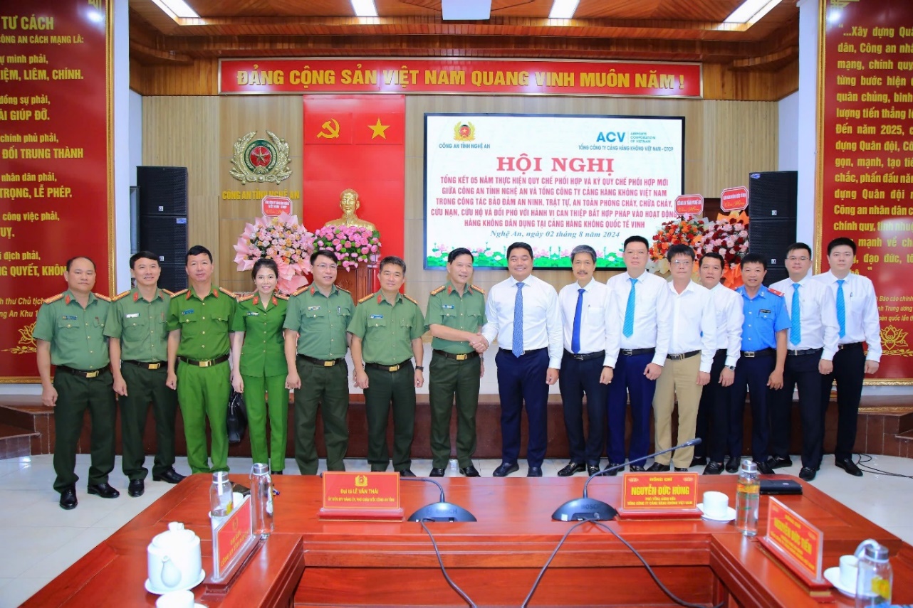 A group of people in uniform standing in front of a large screenDescription automatically generated